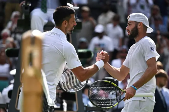 Novak Djokovic shakes hands with Jacob Fearnley