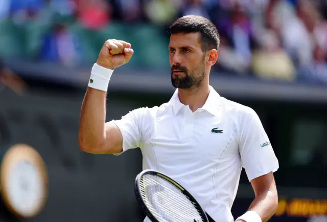 Novak Djokovic clenches his fist in celebration