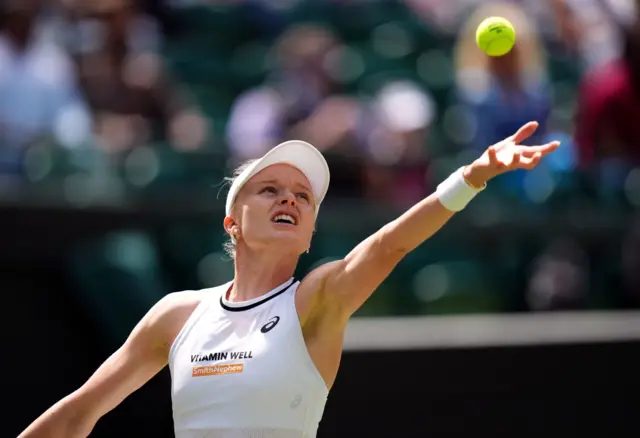 Harriet Dart throws the ball up to serve