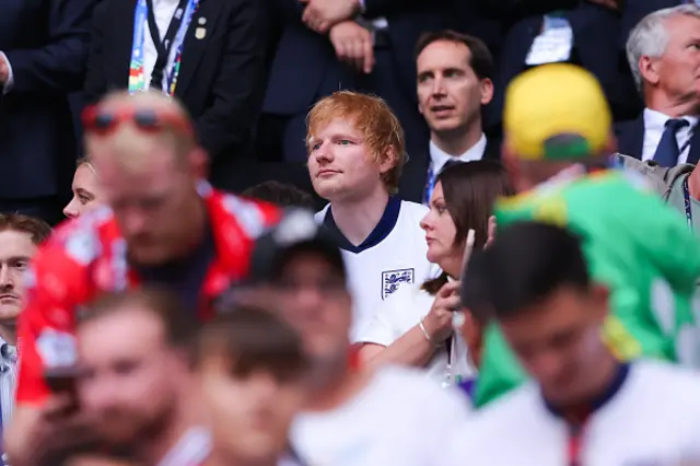 Musician Ed Sheeran watches on