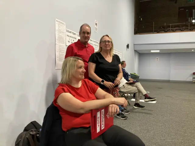 Three Labour Party supporters wearing red