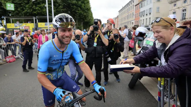 Mark Cavendish smiling as he prepares to start stage six of the 2024 Tour de France