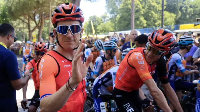 Geraint Thomas waves while waiting for the start of stage two of the 2024 Tour de France