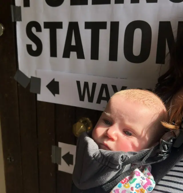 A young baby at a polling station