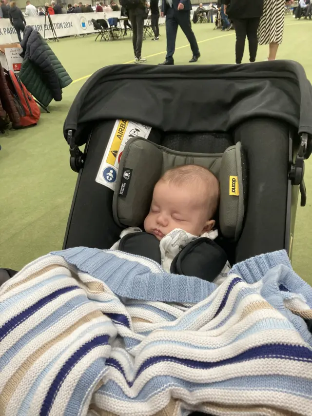 baby with a blanket at election count