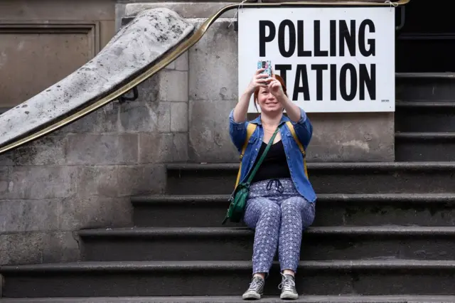 A voter takes a selfie photo at a polling station during voting in the general election at Old Street in London, U.K., on Thursday, June 8, 2017