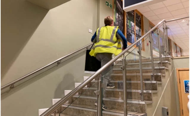 A man running up stairs with a ballot box