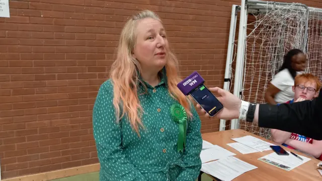 Ms Muckley speaking into a BBC Radio WM-branded microphone