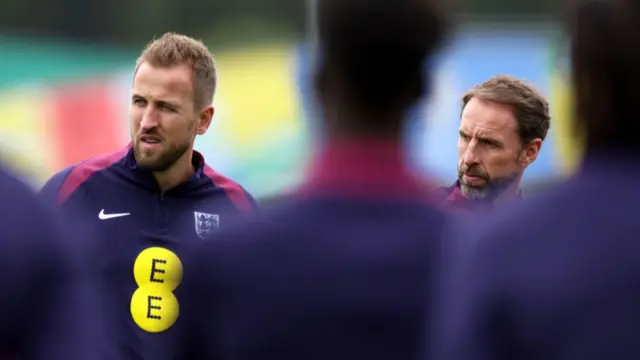 Harry Kane of England and Gareth Southgate, Manager of England men's senior team, look on during a training session at Spa & Golf Resort Weimarer