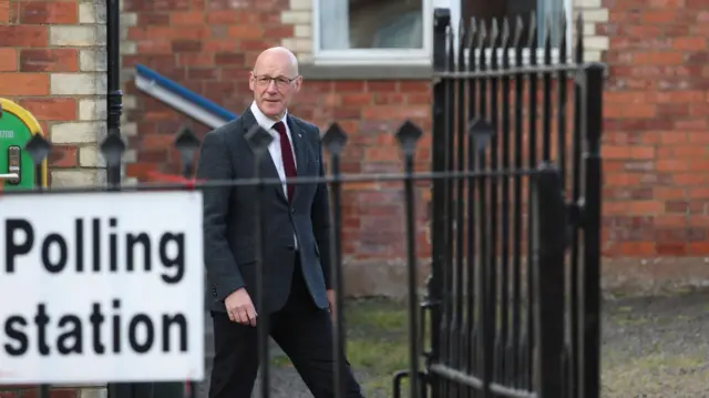 Swinney leaves a polling station