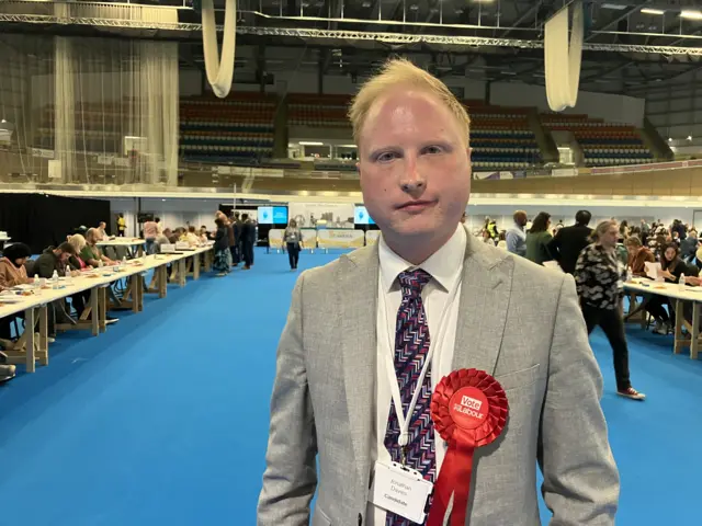 Labour candidate with bright rosette