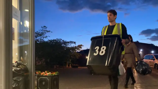 A man carries a ballot box into the count at Bishop Grosseteste University in Lincoln