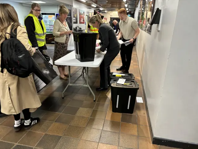 Ballot boxes being checked in at the sports centre