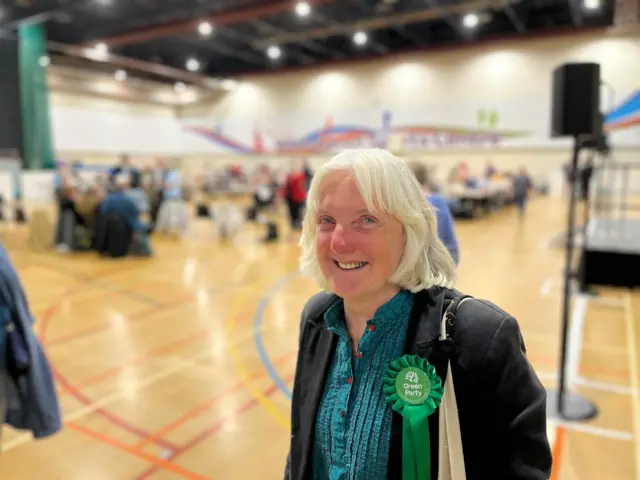 Green party candidate Jill Perry wearing a green rosette on a black jacket