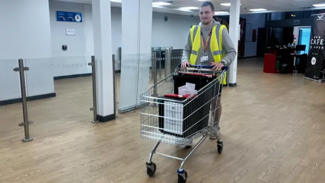 Steady steam of ballet boxes come through the door in carried in Tesco trolleys Newmarket Leisure Centre, Exning Road, Newmarket