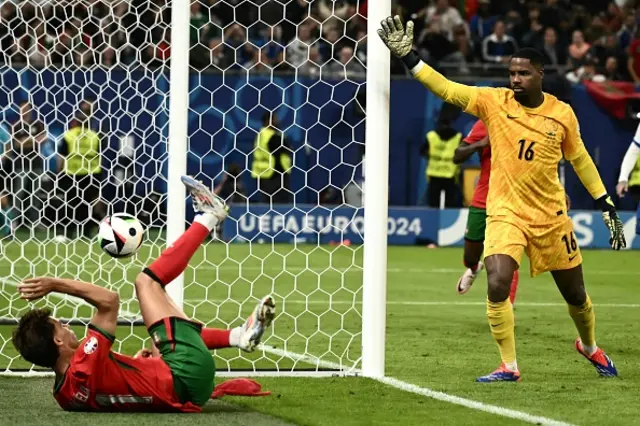 Mike Maignan reacts after Portugal's forward Joao Felix headed the ball