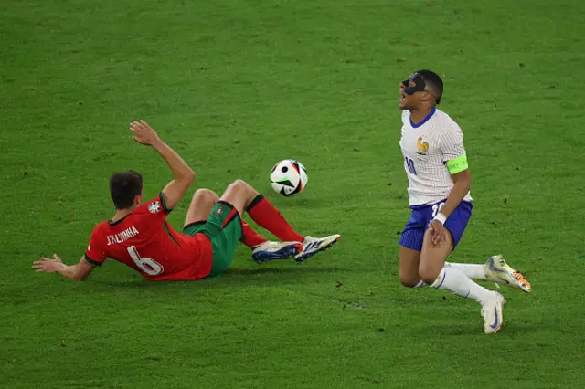 Joao Palhinha and France's forward #10 Kylian Mbappe react a