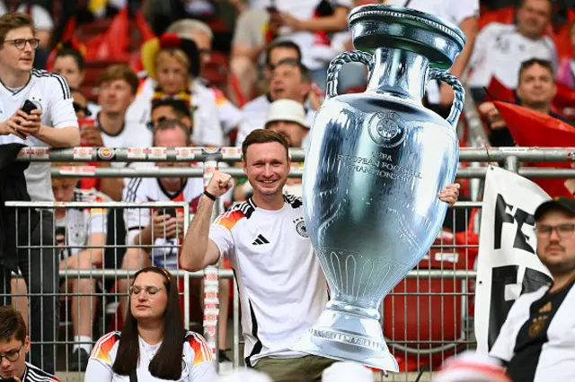 A Germany's supporter holds a fake giant Euro trophy