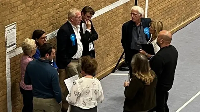 Conservative candidate, Nic Puntis, and supporters grouped together looking concerned