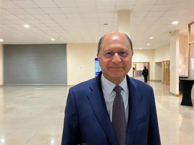 Shailesh Vara looking directly at the camera in a blue suit and tie