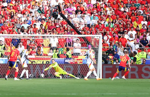 Dani Olmo of Spain scores his team's first goal as Manuel Neuer