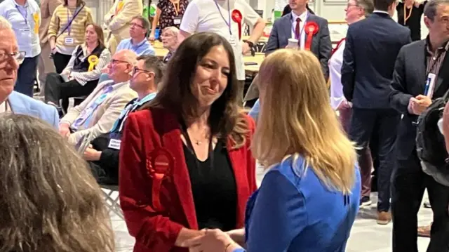 Alice MacDonald shakes hands with Charlotte Salomon