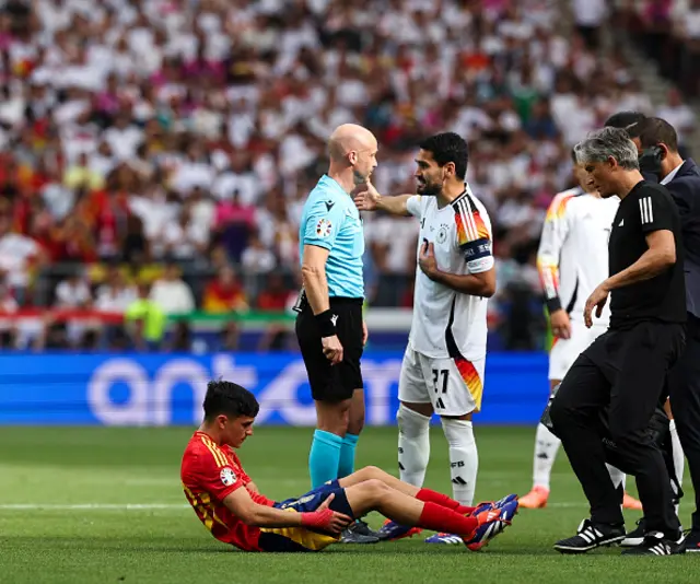 Pedri sits on the pitch injured