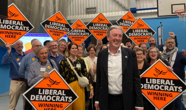 Paul Kohler surrounded by supporters