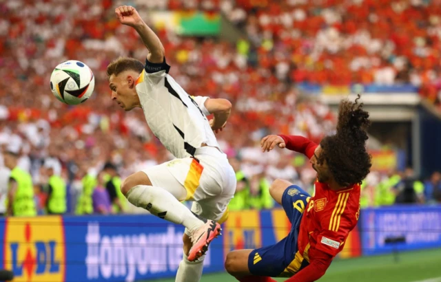 Germany's Joshua Kimmich in action with Spain's Marc Cucurella