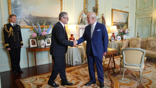 Sir Keir Starmer shaking hands with King Charles