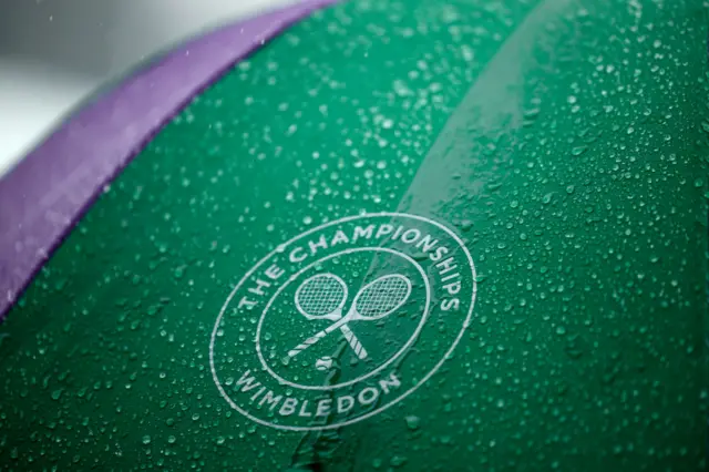 Super close up of a Wimbledon umbrella with many rain drops