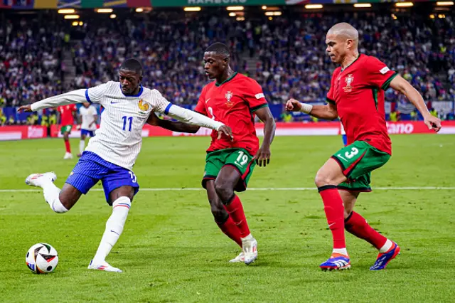 Ousmane Dembele of France shoots and Nuno Mendes of Portugal, Pepe of Portugal try to block it