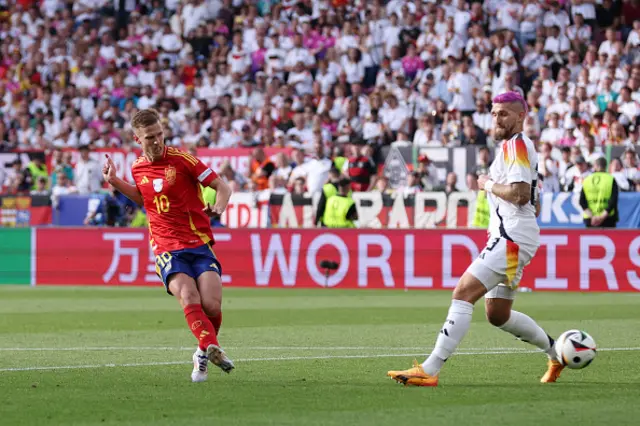 Dani Olmo of Spain scores his team's first goal whilst under pressure from Robert Andrich