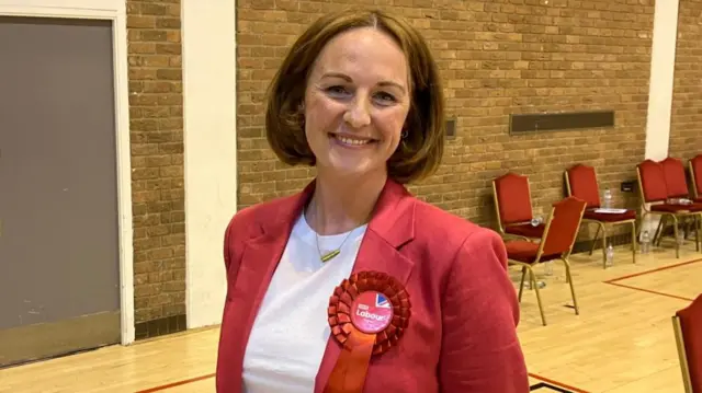 A woman smiles at the camera