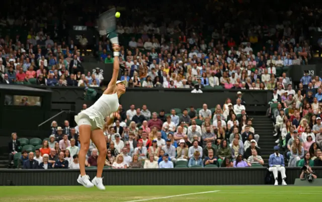 Raducanu serves