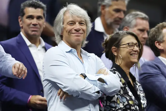 Bon Jovi smiles in the stands of the Arthur Ashe Stadium at the US Open