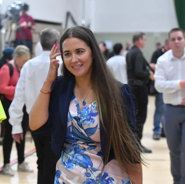 Women in blue dress at polling count.