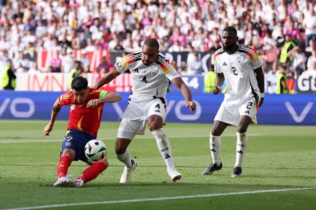 Alvaro Morata of Spain shoots whilst under pressure from Jonathan Tah