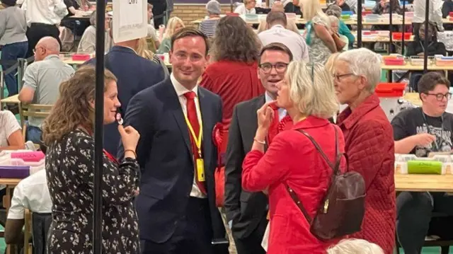 Labour members, including Tom Hayes, wearing a red tie, waiting for the result in Bournemouth East