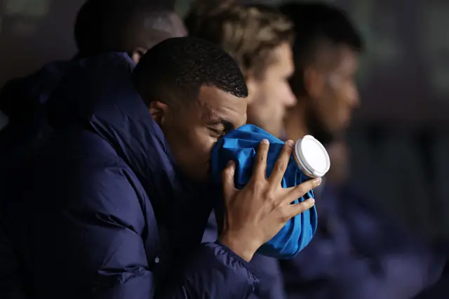 Kylian Mbappe of France holds an ice pack on his nose