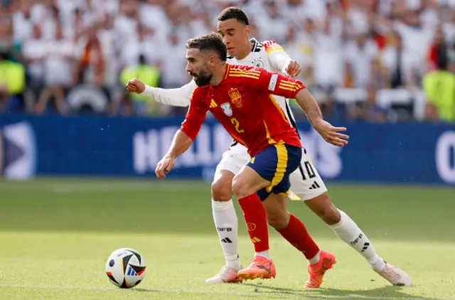 Daniel Carvajal of Spain and Jamal Musiala of Germany challenge