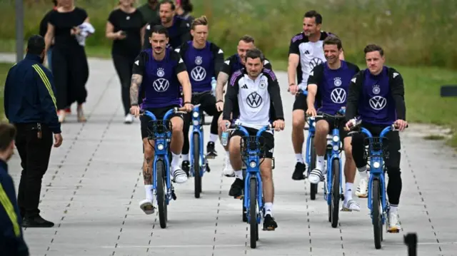 Germany players riding bikes in Herzogenaurach,