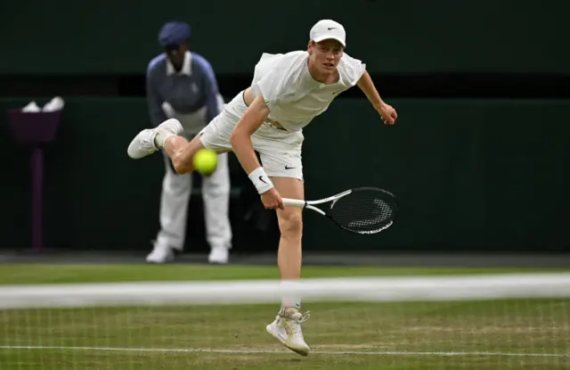 Jannik Sinner serves the ball