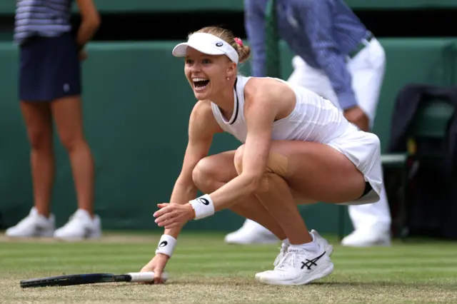 Harriet Dart on her haunches celebrating after victory