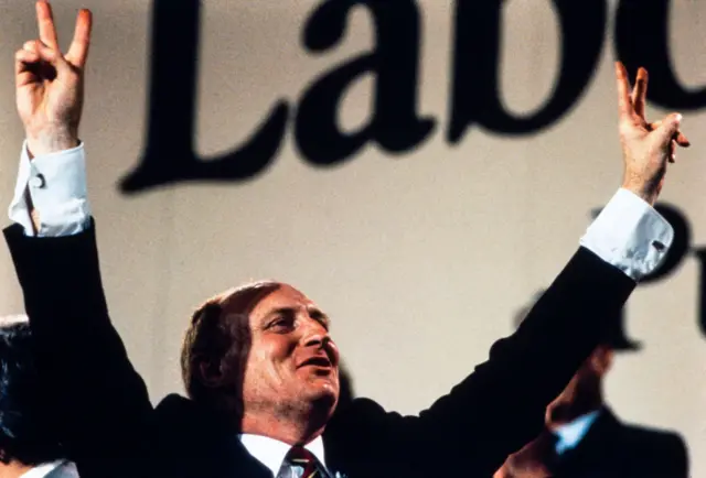 Kinnock holds up his arms