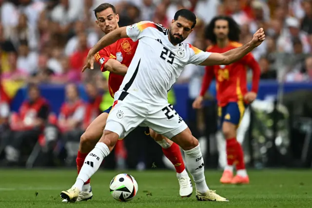 Fabian Ruiz fights for the ball with Germany's midfielder Emre Can