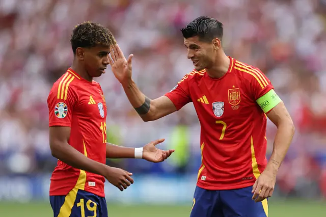 Alvaro Morata of Spain interacts with Lamine Yamal