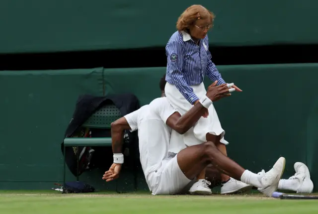 Gael Monfils slips into a line judge