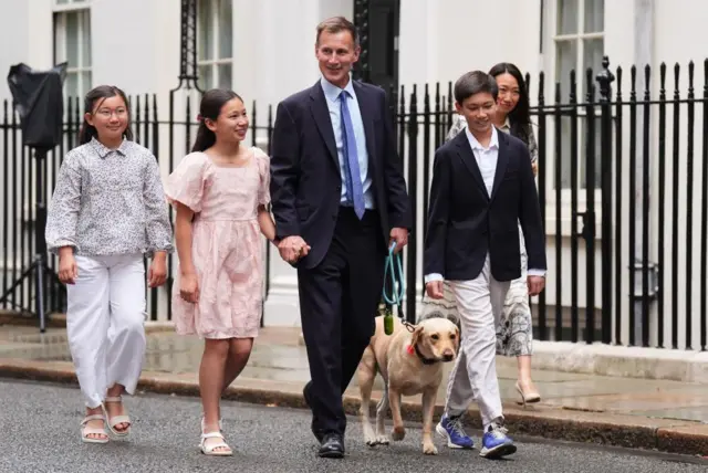 Jeremy Hunt walks with his family and their dog