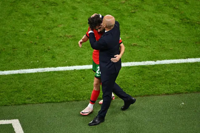 Vitinha of Portugal is embraced by Roberto Martinez